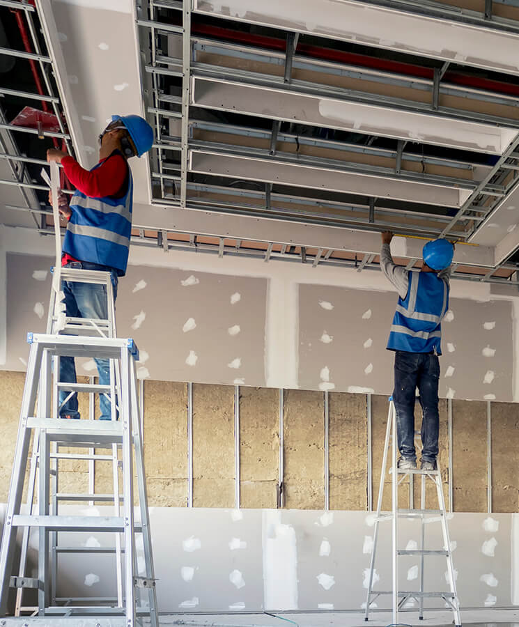 Construction worker installing ceiling